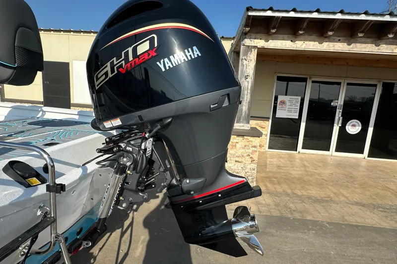 Slide: The Image of 2026 Express H22B boat with Yamaha SHO VMAX outboard motor, parked outside a building. - 6