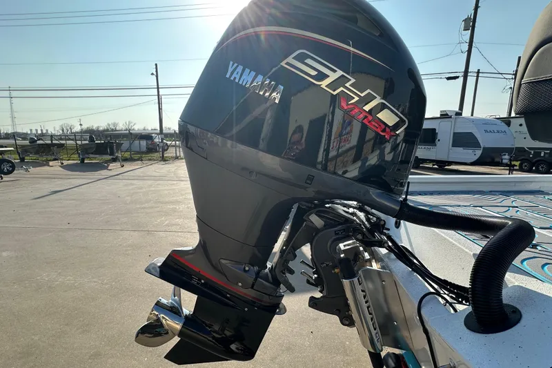 Slide: The Image of 2026 Express H22B boat with Yamaha SHO VMAX outboard motor in a parking lot. - 7