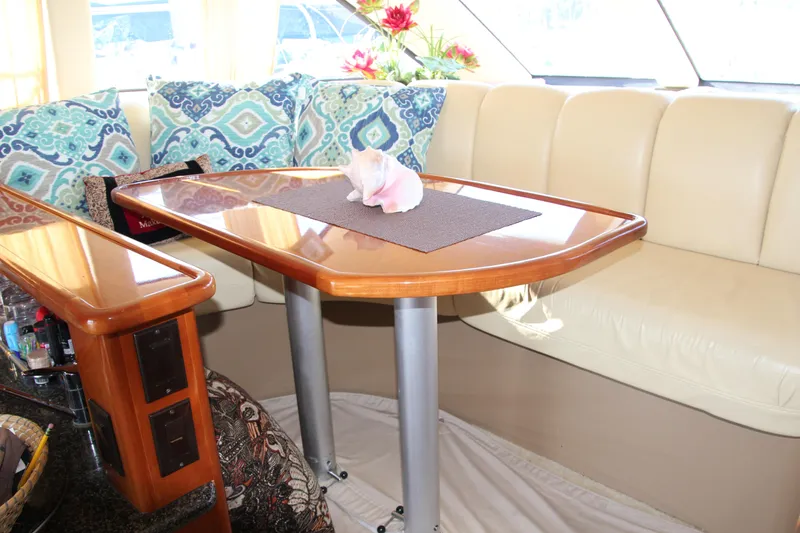 Slide: The Image of Interior of 2004 Carver 360 Sport Sedan with elegant dining area and decorative cushions. - 11