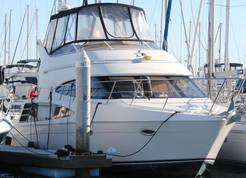 Slide: The Image of 2004 Carver 360 Sport Sedan yacht docked at marina, surrounded by sailboats. - 8