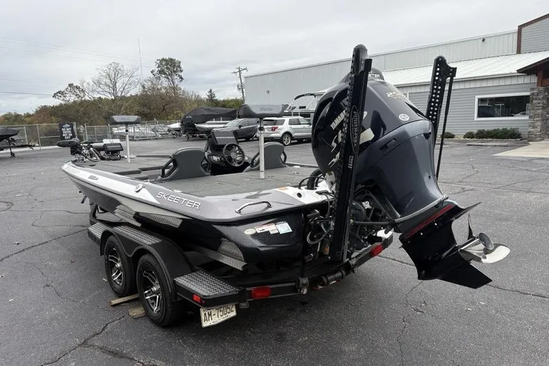 Slide: The Image of 2021 Skeeter ZXR20 boat with Yamaha engine on a trailer in a parking lot. - 13