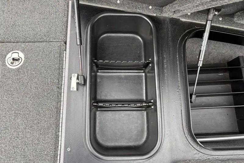 Slide: The Image of 2021 Skeeter ZXR20 boat storage compartment with hydraulic lift and carpeted interior. - 14
