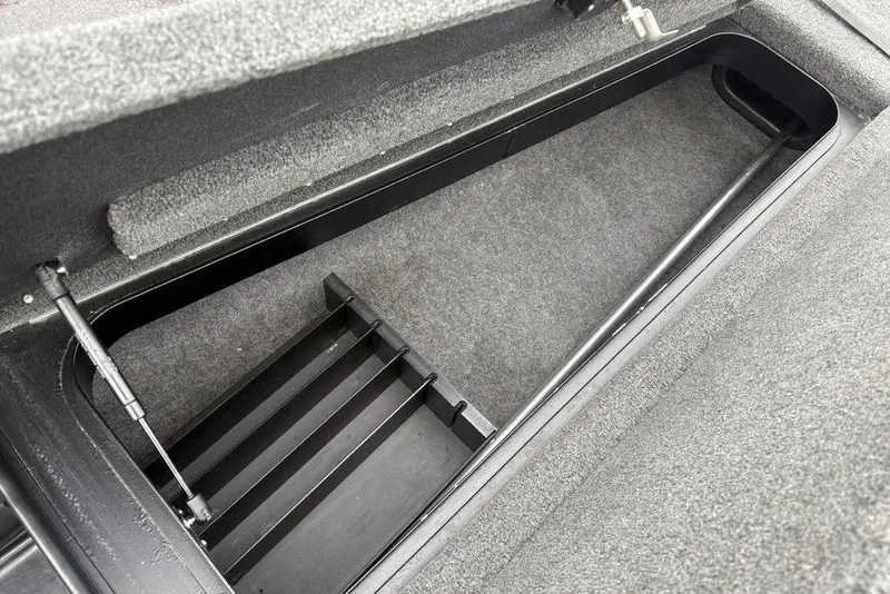 Slide: The Image of 2021 Skeeter ZXR20 storage compartment with carpeted interior and hydraulic lift support. - 16