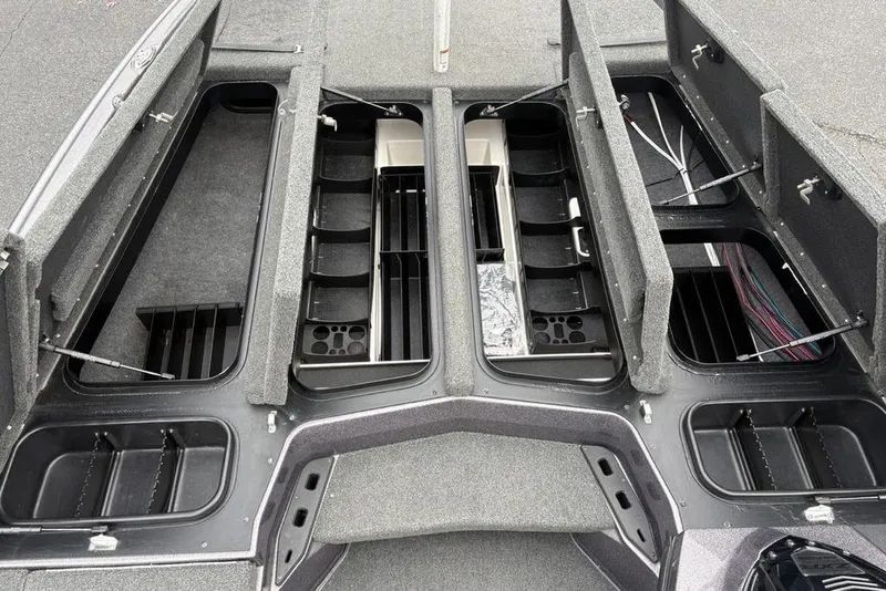 Slide: The Image of 2021 Skeeter ZXR20 boat storage compartments with open lids and organized interior layout. - 19