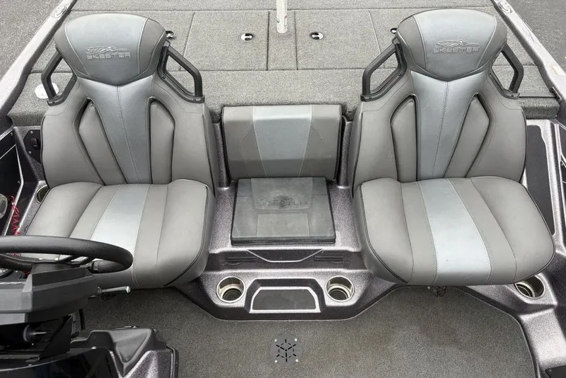 Slide: The Image of 2021 Skeeter ZXR20 boat interior with dual gray seats and steering wheel. - 20