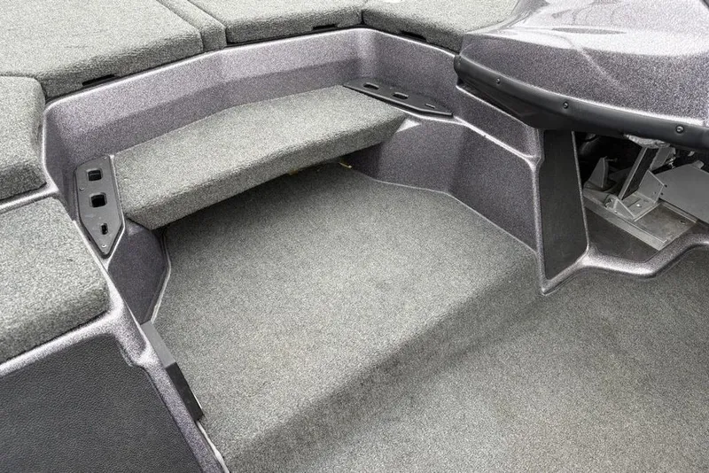 Slide: The Image of 2021 Skeeter ZXR20 boat interior with carpeted deck and storage compartments. - 22