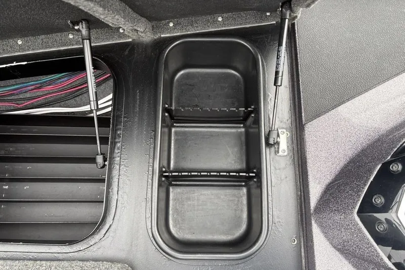 Slide: The Image of Open storage compartment in a 2021 Skeeter ZXR20 boat, featuring hydraulic struts. - 23