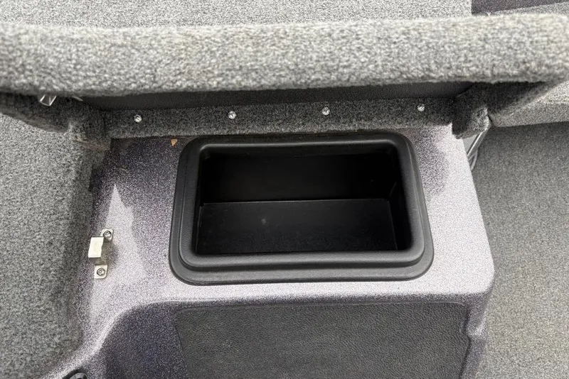 Slide: The Image of Storage compartment in 2021 Skeeter ZXR20 boat, featuring carpeted interior and secure latch. - 24