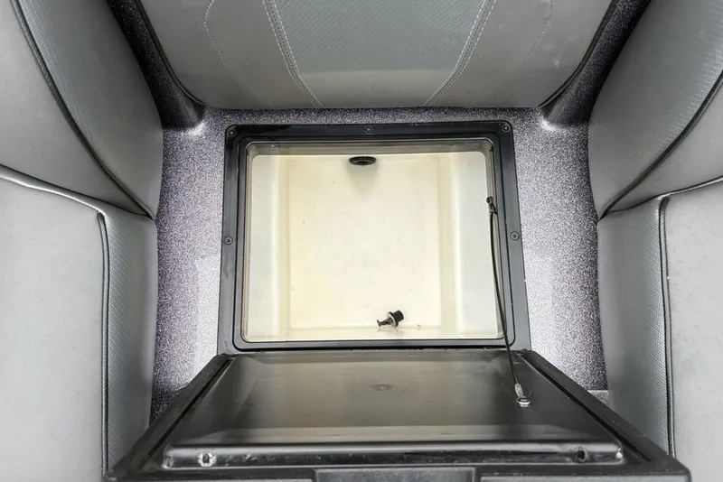 Slide: The Image of 2021 Skeeter ZXR20 boat storage compartment with open lid, showcasing interior space. - 27