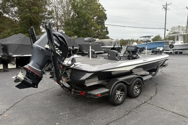 Slide: The Image of 2021 Skeeter ZXR20 boat with Yamaha engine on a trailer in a parking lot. - 3