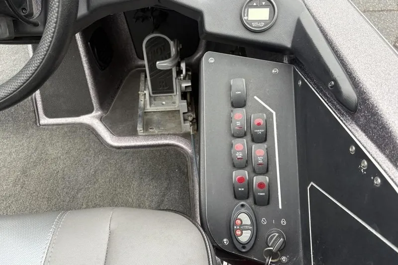 Slide: The Image of Control panel of a 2021 Skeeter ZXR20 boat with switches and pedal. - 32