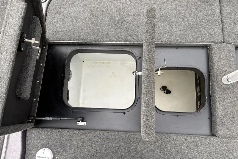 Slide: The Image of 2021 Skeeter ZXR20 boat storage compartments with open hatches, showcasing interior space. - 36
