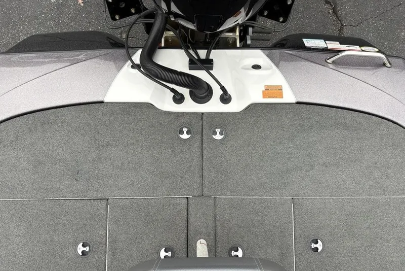 Slide: The Image of 2021 Skeeter ZXR20 boat deck with gray carpeting and motor controls. - 38