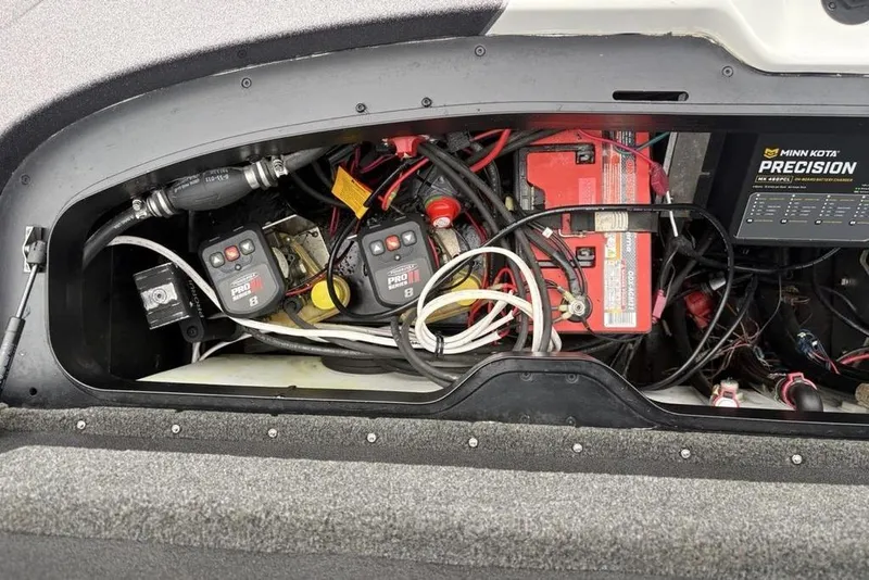 Slide: The Image of 2021 Skeeter ZXR20 boat battery compartment with wiring and Minn Kota Precision charger. - 40