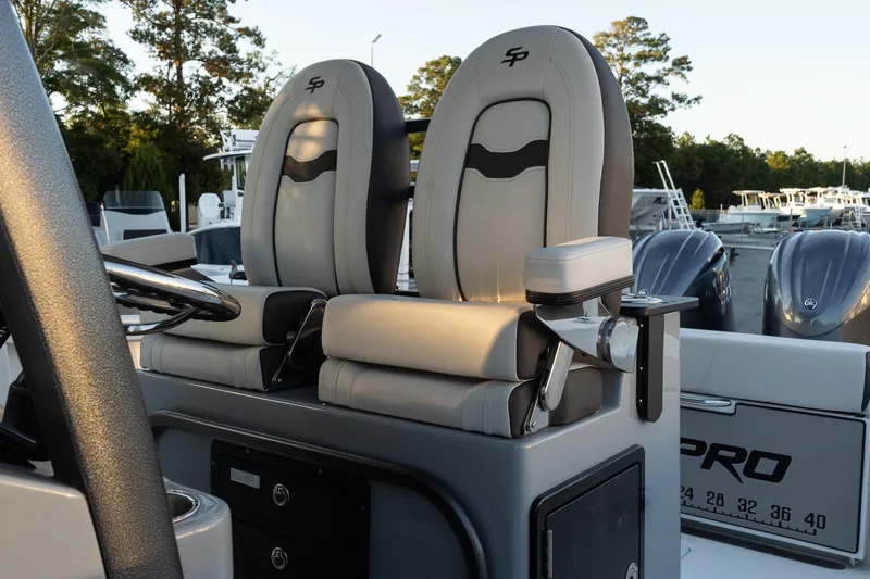 Slide: The Image of 2026 Sea Pro 262 Offshore boat interior with dual captain's chairs and steering console. - 12