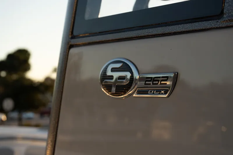 Slide: The Image of 2026 Sea Pro 262 Offshore emblem on boat exterior in sunlight. - 15