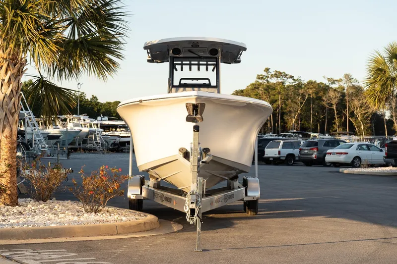 Slide: The Image of 2026 Sea Pro 262 Offshore boat on trailer in parking lot, surrounded by palm trees. - 3