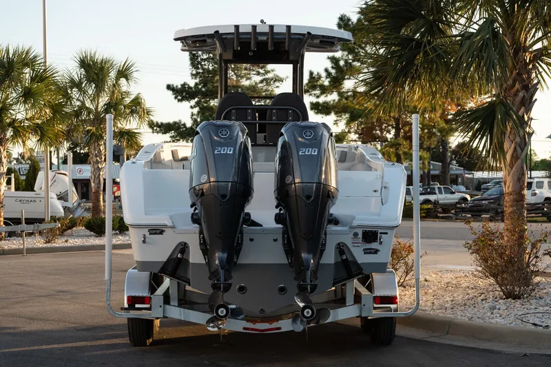 Slide: The Image of 2026 Sea Pro 262 Offshore boat with dual 200 horsepower engines, parked near palm trees. - 5