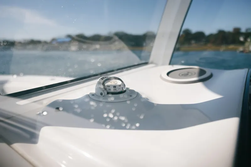 Slide: The Image of Compass on 2019 Sea Hunt Gamefish 27 Coffin Box boat dashboard, sunny day. - 12