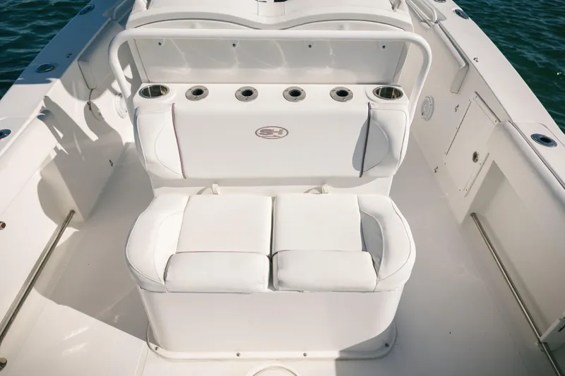 Slide: The Image of 2019 Sea Hunt Gamefish 27 Coffin Box boat interior with cushioned seating and rod holders. - 14