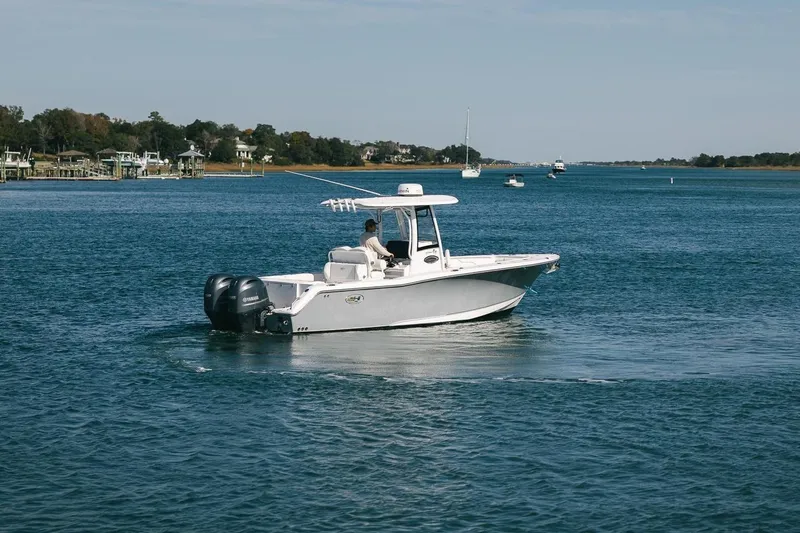 Slide: The Image of 2019 Sea Hunt Gamefish 27 Coffin Box boat cruising on a calm lake. - 2