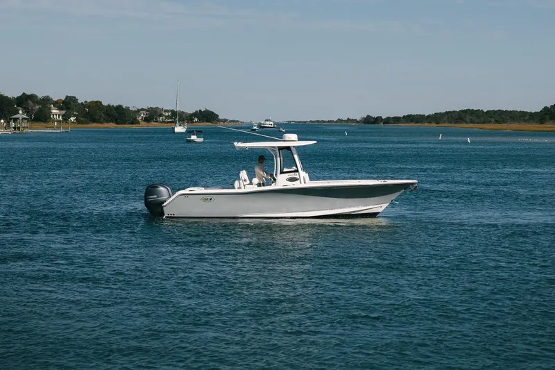 Slide: The Image of 2019 Sea Hunt Gamefish 27 Coffin Box boat cruising on a serene waterway. - 3