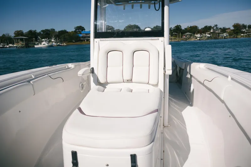 Slide: The Image of 2019 Sea Hunt Gamefish 27 Coffin Box boat interior with white seating on water. - 5