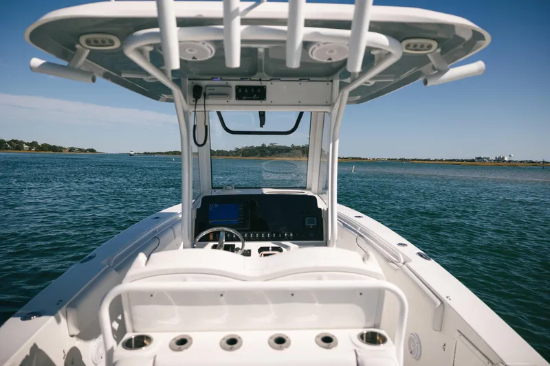 Slide: The Image of 2019 Sea Hunt Gamefish 27 Coffin Box boat on open water, clear sky. - 6