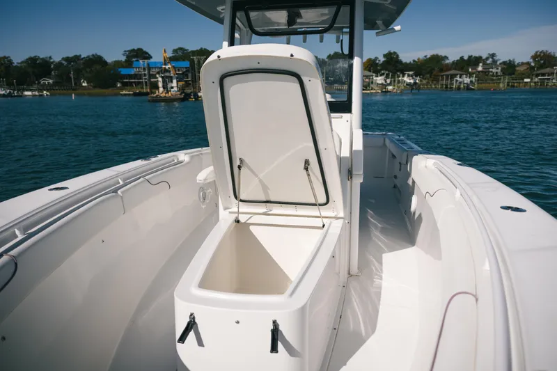 Slide: The Image of 2019 Sea Hunt Gamefish 27 Coffin Box boat with open storage, on calm water. - 8