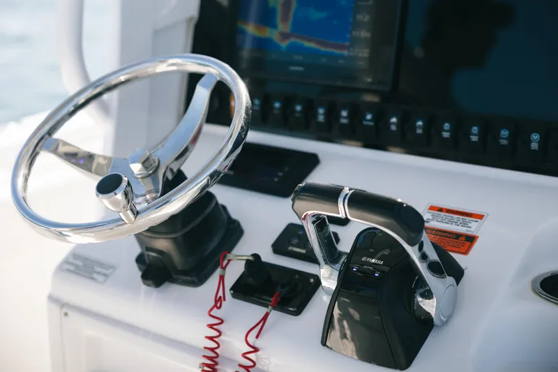 Slide: The Image of 2019 Sea Hunt Gamefish 27 Coffin Box helm with steering wheel and controls. - 9