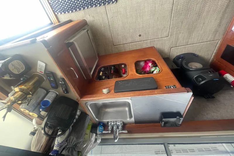 Slide: The Image of 1983 Bayliner 3888 MY Sedan galley with sink, storage, and appliances. - 15