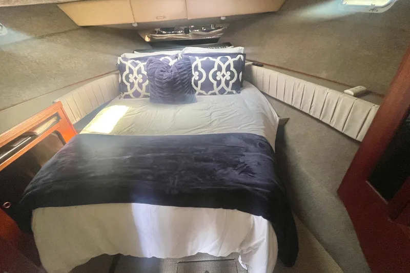 Slide: The Image of Cozy bedroom interior of 1983 Bayliner 3888 MY Sedan yacht with plush bedding. - 19