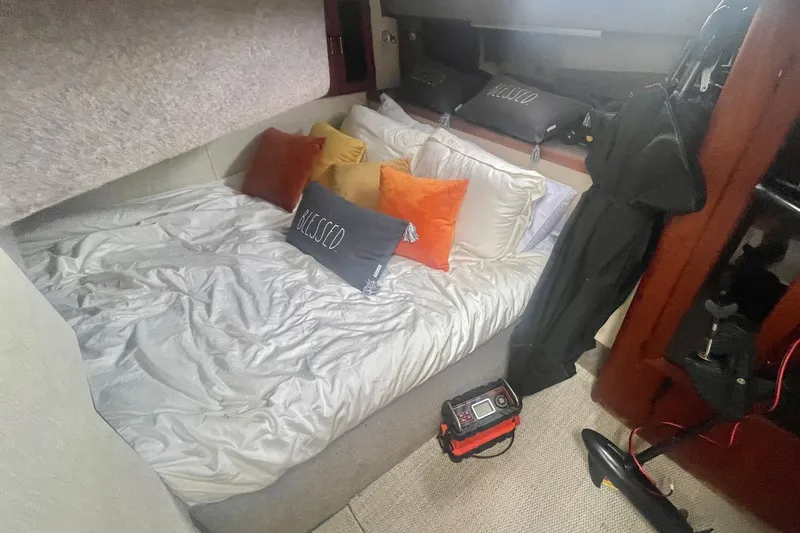 Slide: The Image of Cozy cabin interior of 1983 Bayliner 3888 MY Sedan with pillows and bedding. - 23