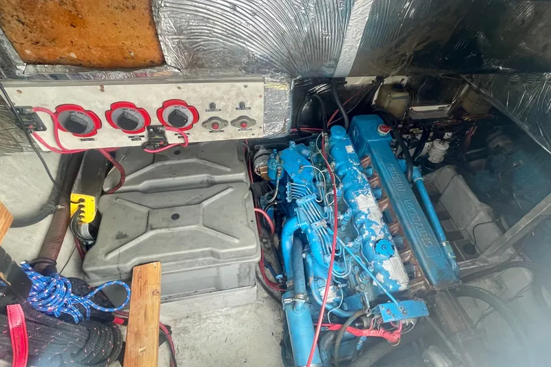 Slide: The Image of Engine room of 1983 Bayliner 3888 MY Sedan with blue engine and control panel. - 24