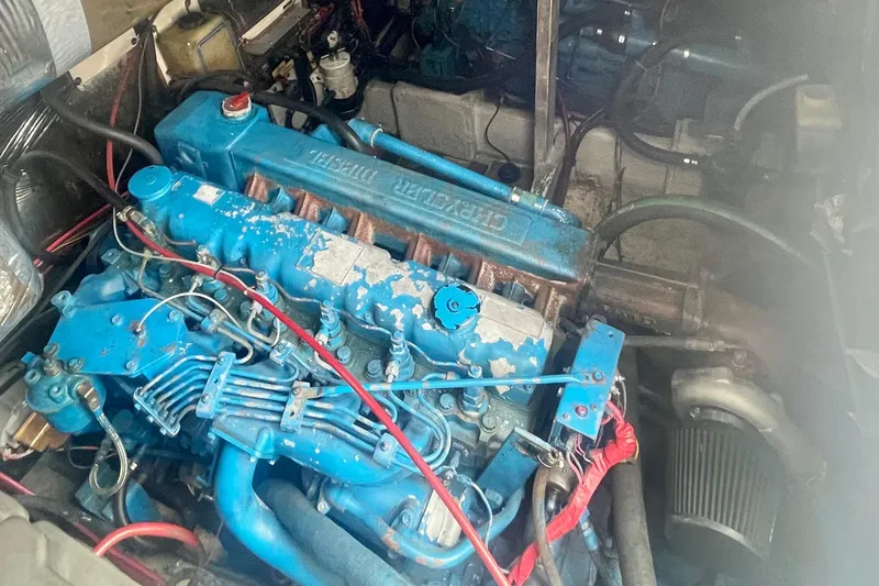 Slide: The Image of Engine of 1983 Bayliner 3888 MY Sedan, showcasing blue diesel components. - 25