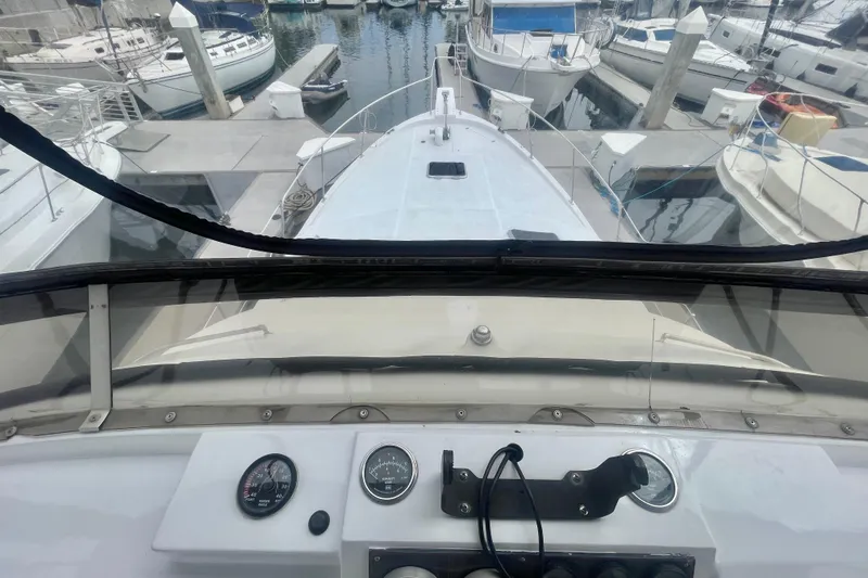 Slide: The Image of 1983 Bayliner 3888 MY Sedan yacht docked at marina, view from helm. - 5