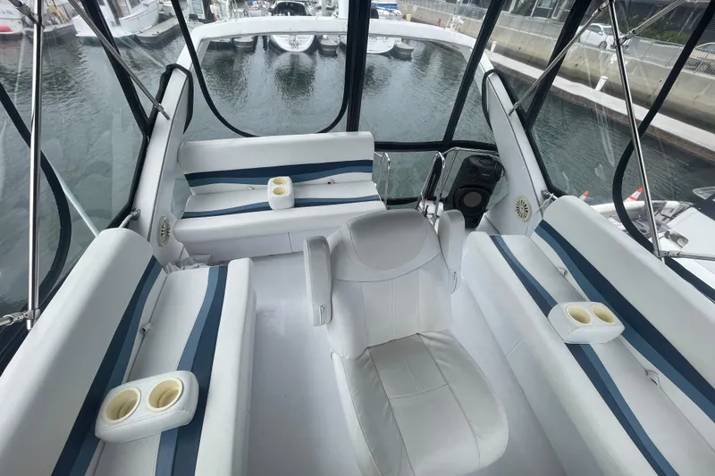 Slide: The Image of 1983 Bayliner 3888 MY Sedan interior with white seating and cup holders. - 8