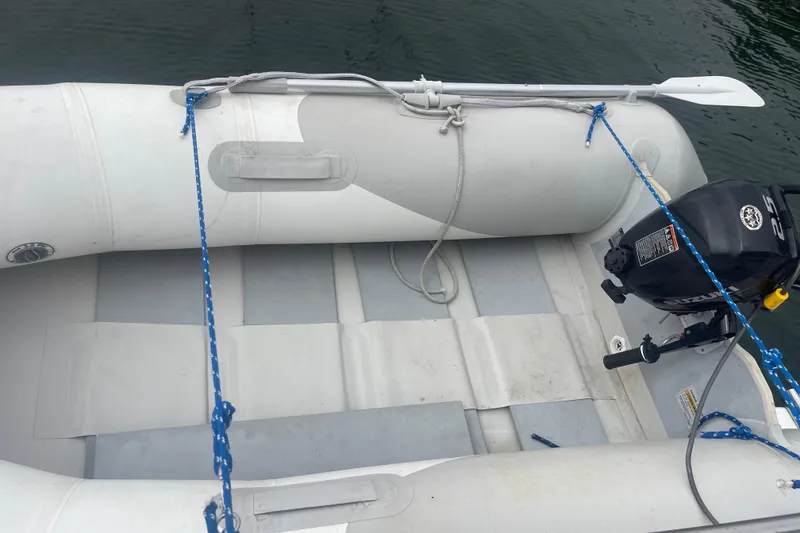 Slide: The Image of Inflatable boat with motor, tied with blue ropes, near water. Bayliner 3888 MY Sedan, 1983. - 9