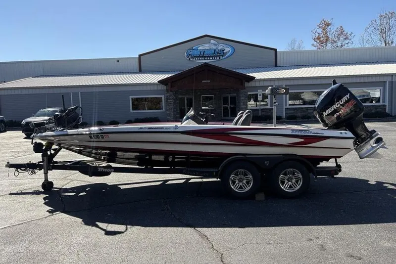 The Image of 2018 Triton 20 TrX Patriot boat on trailer, parked outside a dealership. - 1