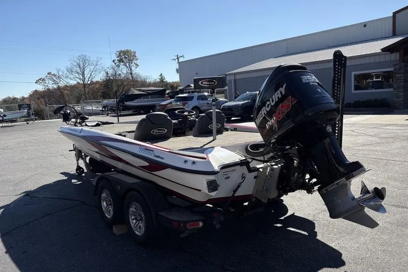 Slide: The Image of 2018 Triton 20 TrX Patriot boat with Mercury Pro XS engine in a parking lot. - 12