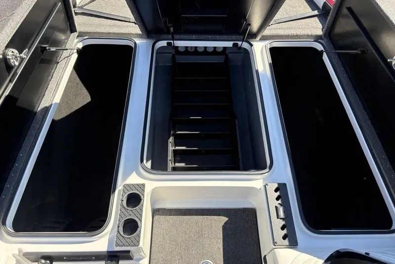 Slide: The Image of 2018 Triton 20 TrX Patriot boat storage compartments, open and empty, showcasing interior layout. - 19
