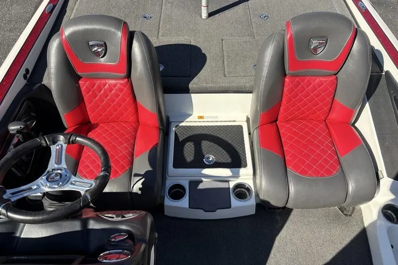Slide: The Image of 2018 Triton 20 TrX Patriot boat interior with red and gray seats, steering wheel, and console. - 20
