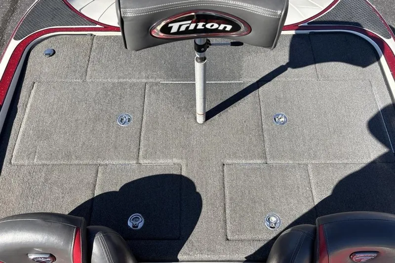 Slide: The Image of 2018 Triton 20 TrX Patriot boat deck with gray carpet and seating. - 25