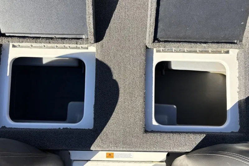 Slide: The Image of 2018 Triton 20 TrX Patriot boat storage compartments with open lids, showcasing interior space. - 26
