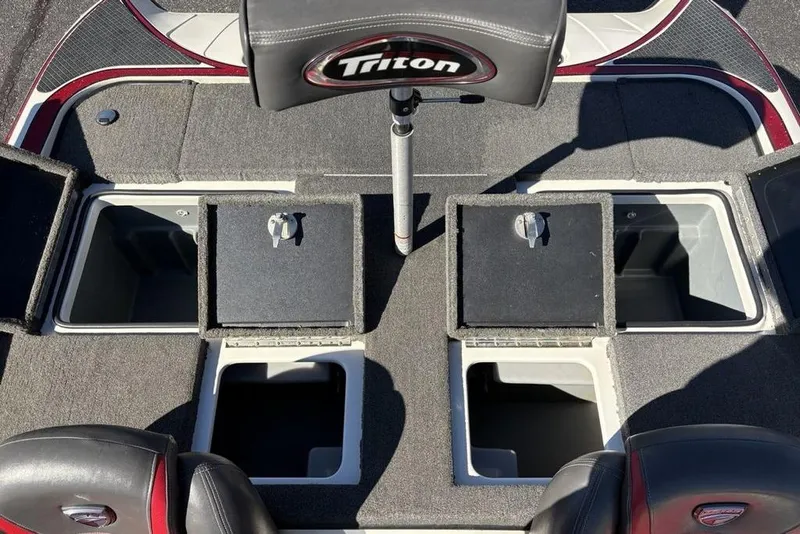 Slide: The Image of 2018 Triton 20 TrX Patriot boat interior with open storage compartments and seating. - 28