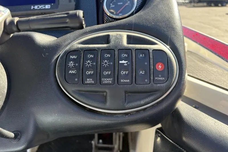 Slide: The Image of Control panel of a 2018 Triton 20 TrX Patriot boat with various switches. - 29