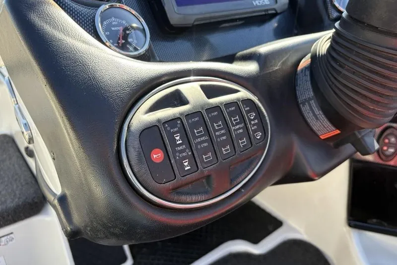 Slide: The Image of Control panel of a 2018 Triton 20 TrX Patriot boat with various switches and gauges. - 30