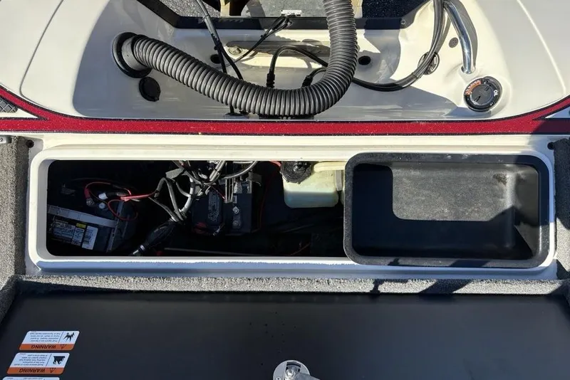 Slide: The Image of 2018 Triton 20 TrX Patriot boat interior showing battery compartment and wiring. - 34
