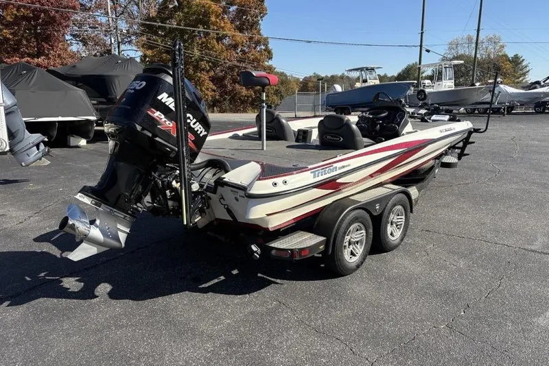 Slide: The Image of 2018 Triton 20 TrX Patriot boat with Mercury engine on a trailer in a parking lot. - 4