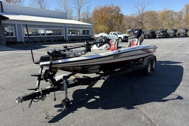 Slide: The Image of 2018 Triton 20 TrX Patriot boat on trailer in parking lot, sunny day. - 5